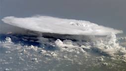 Herds of anvil-shaped clouds form in the tropics as part of the Madden-Julian Oscillation, a pattern of shifting winds and rain that starts over the Indian Ocean and travels eastward every 30 to 90 days. This image, taken from the International Space Station over western Africa, shows the complex nature of these systems. 