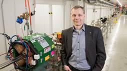 Director Sergei Nagaitsev stands in front of an accelerator beamline under construction at the Fermilab Accelerator Complex. 